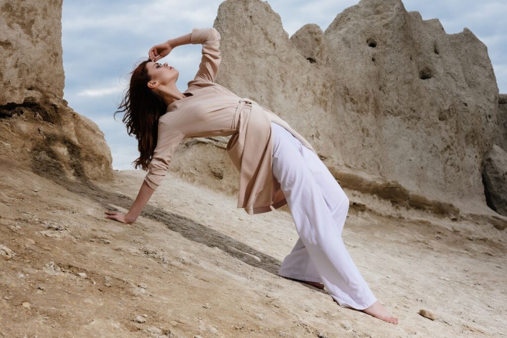 Beige White Outfit | Elegant | Model poses on rocks